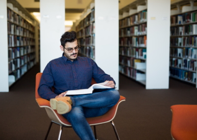 Student reading a book in the library